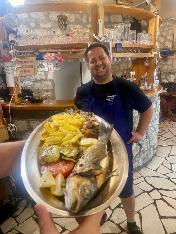 Proudly with a smile serving Grilled Fish Platter Škojera