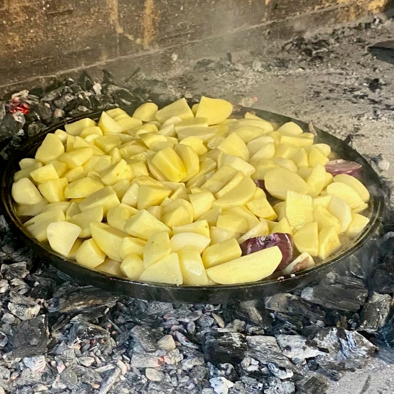 meat and potatoes under peka